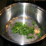 Choped cilantro in the deep side frying pan